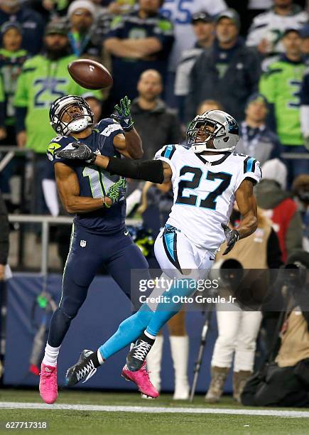 Wide receiver Tyler Lockett of the Seattle Seahawks can't hold on to a catch against cornerback Robert McClain of the Carolina Panthers at...