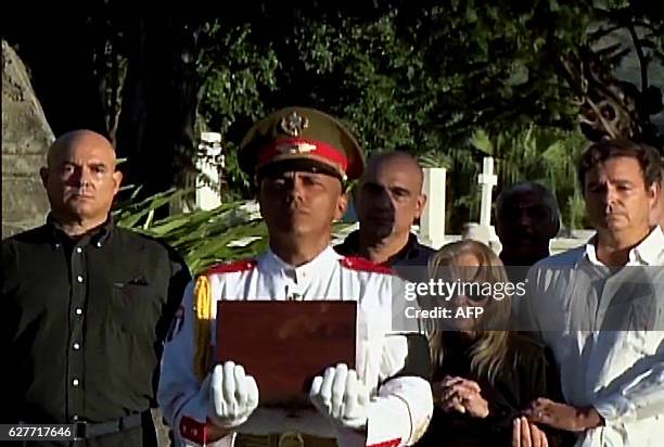 This grab from CubanTV shows the family of late Cuban leader Fidel Castro, , Alex Castro, Alejandro Castro, his widow Dalia Soto del Valle and...