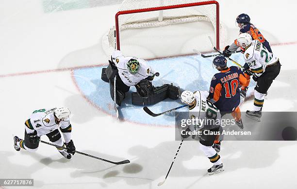 Tyler Parsons of the London Knights makes a stop against the Flint Firebirds during an OHL game at Budweiser Gardens on December 4, 2016 in London,...