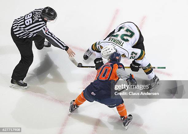 Ryan Moore of the Flint Firebirds takes a faceoff against Robert Thomas of the London Knights during an OHL game at Budweiser Gardens on December 4,...