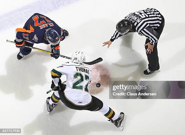 Everett Clark of the Flint Firebirds takes a faceoff against Robert Thomas of the London Knights during an OHL game at Budweiser Gardens on December...