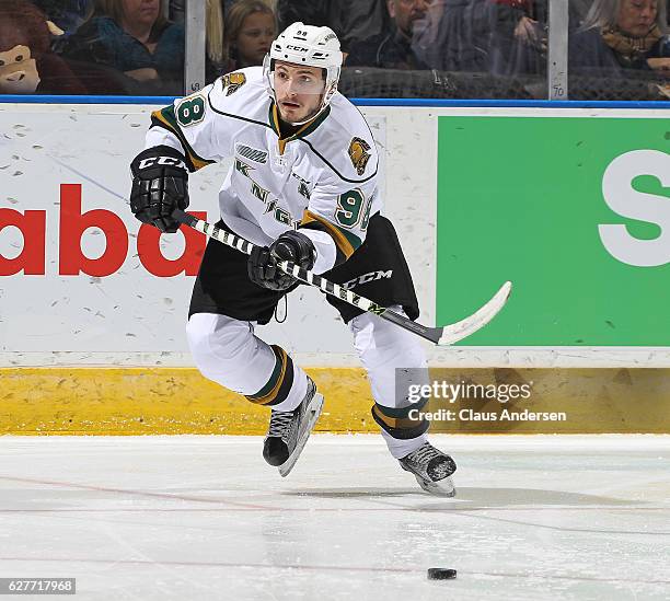 Victor Mete of the London Knights skates with the puck against the Flint Firebirds during an OHL game at Budweiser Gardens on December 4, 2016 in...