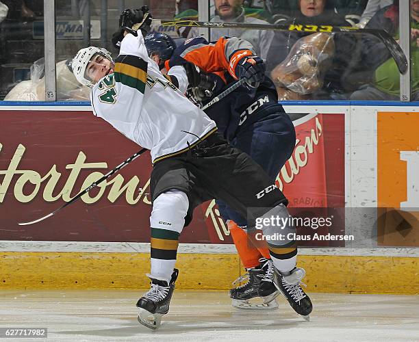 Jacob Golden of the London Knights takes a big hit against the Flint Firebirds during an OHL game at Budweiser Gardens on December 4, 2016 in London,...