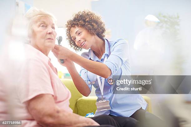 ent examination - ear exam stock pictures, royalty-free photos & images