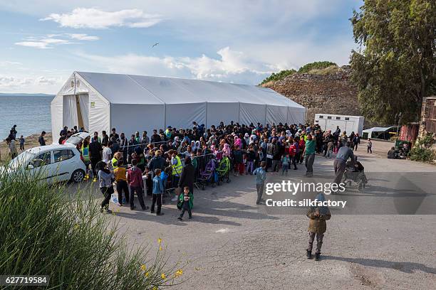 breakfast line in souda refugee camp on chios - refugees stock pictures, royalty-free photos & images