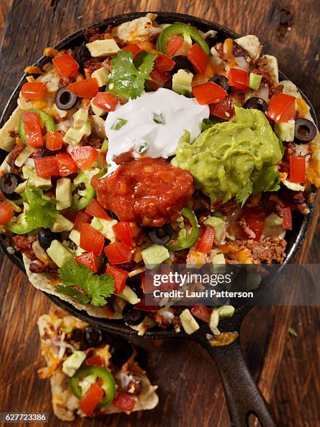 beef skillet nachos - sour cream stock pictures, royalty-free photos & images