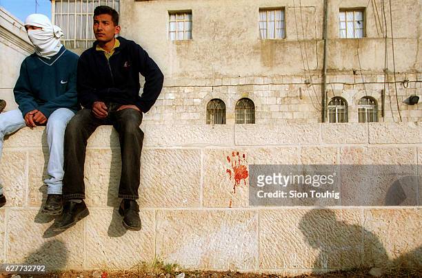Bloody handprint marks the site of the fatal shooting of 16-year-old Palestinian Amar Mehnies during a clash with the Israeli Army after Friday...