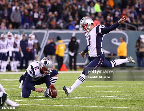 Ryan Allen of the New England Patriots holds for Stephen Gostkowski of the New England Patriots against the New York Jets during their game at...