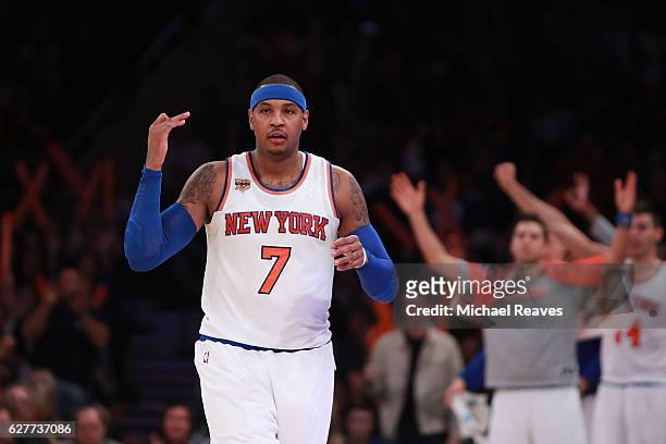 Carmelo Anthony of the New York Knicks reacts after making a three pointer against the Sacramento Kings during the second half at Madison Square...