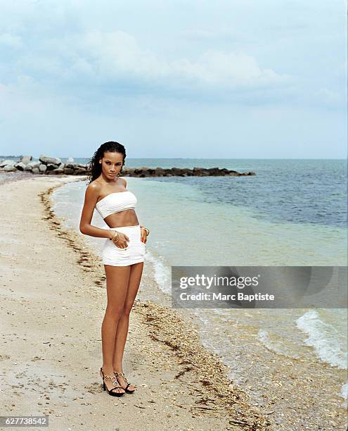 Agnes Cammock, Hair: Dante Blandshaw, Makeup: Natasha Morgan, Manicure: Donna D. Bandeau, swim skirt, and bangles by Chanel. Shoes by Sergio Rossi.