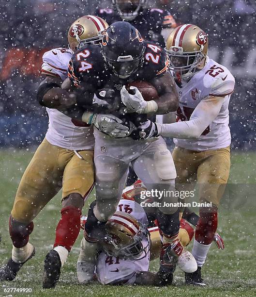 Jordan Howard of the Chicago Bears is tackled by Gerald Hodges and Jimmie Ward of the San Francisco 49ers after running for a first down at Soldier...