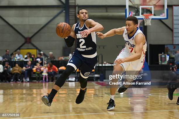 Ray McCallum of the Grand Rapids Drive handles the ball through coverage by Brandon Triche of the Delaware 87ers at the DeltaPlex Arena on December...