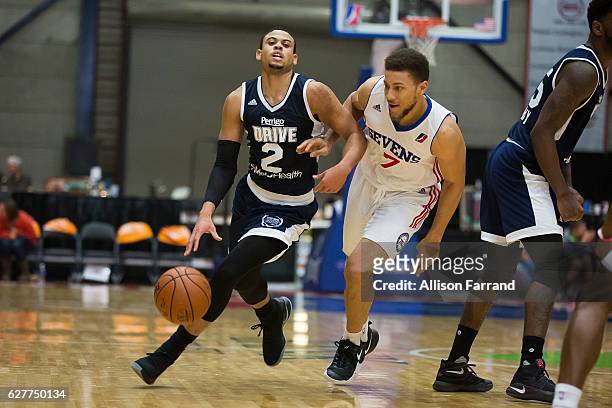 Ray McCallum of the Grand Rapids Drive handles the ball through coverage by Brandon Triche of the Delaware 87ers at the DeltaPlex Arena on December...