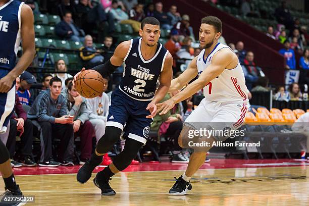 Ray McCallum of the Grand Rapids Drive handles the ball through coverage by Brandon Triche of the Delaware 87ers at the DeltaPlex Arena on December...