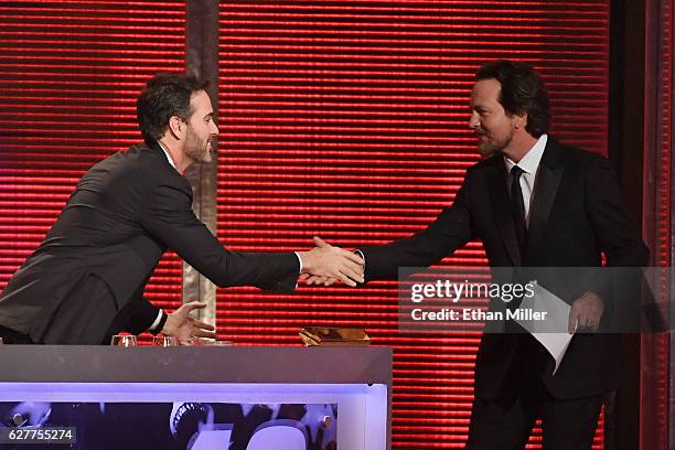 Sprint Cup Series Champion Jimmie Johnson greets singer/guitarist Eddie Vedder of Pearl Jam during the 2016 NASCAR Sprint Cup Series Awards show at...