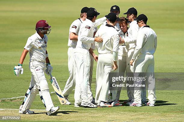 Joe Burns of Queensland walks back to the rooms after being dismissed by Josh Nicholas of Western Australia during day one of the Sheffield Shield...