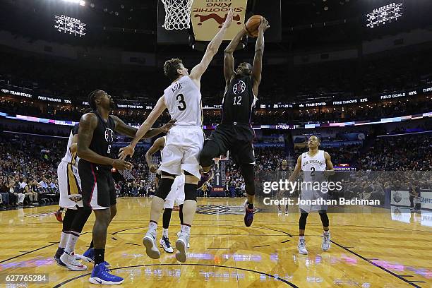 Luc Mbah a Moute of the LA Clippers drives against Omer Asik of the New Orleans Pelicans during the first half of a game at the Smoothie King Center...