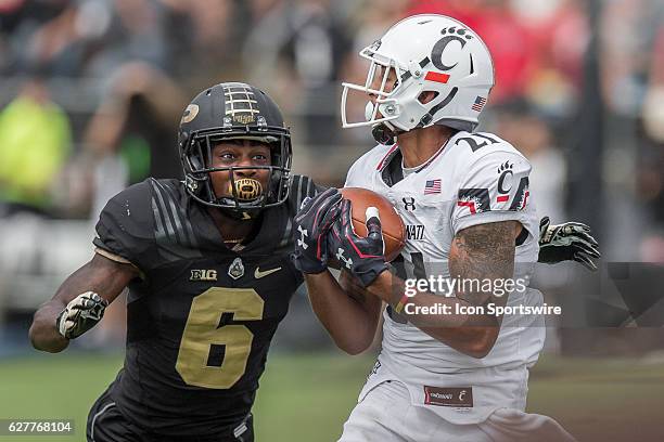 Cincinnati Bearcats wide receiver Devin Gray catches a pass over Purdue University cornerback Myles Norwood during the NCAA football game between the...