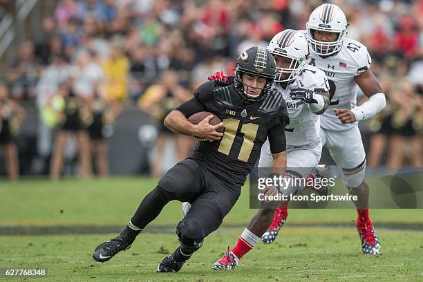 Purdue University quarterback David Blough scrambles during the NCAA football game between the Purdue Boilermakers and Cincinnati Bearcats at...