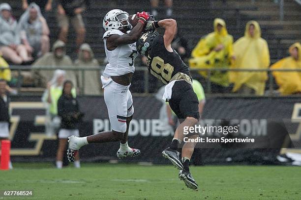 Cincinnati Bearcats safety Mike Tyson intercepts a pass intended for Purdue University wide receiver Cameron Posey during the NCAA football game...