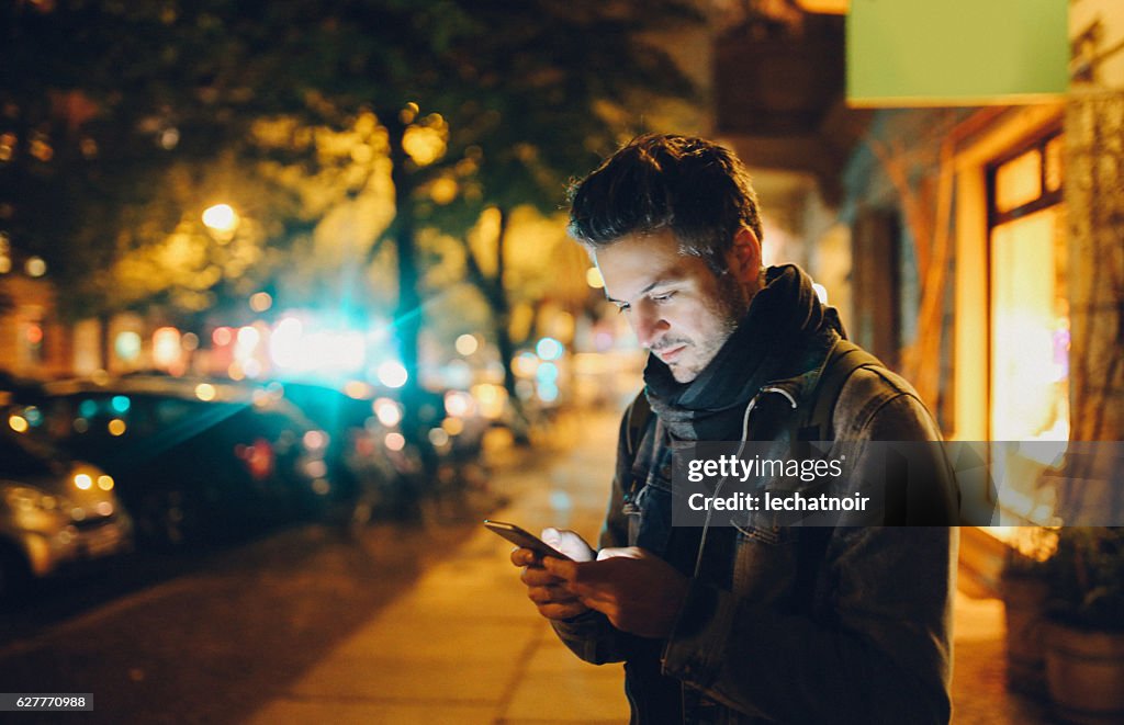 Young man texting in Berlin