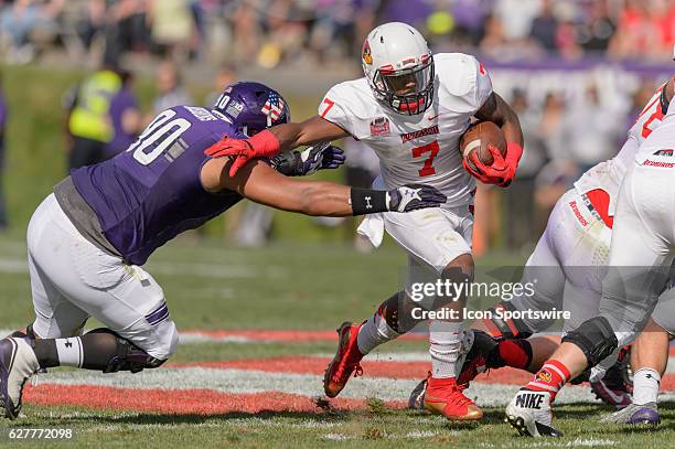 Illinois State Redbirds running back George Moreira is tackled by Northwestern Wildcats defensive lineman C.J. Robbins during an NCAA football game...