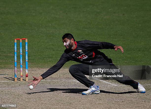 Ahmed Raza of UAE fields the ball during the third match between United Arab Emirates and England Lions at Dubai Cricket Stadium on December 5, 2016...