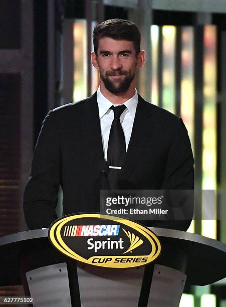 Olympic swimmer Michael Phelps introduces NASCAR Sprint Cup Series Champion Jimmie Johnson during the 2016 NASCAR Sprint Cup Series Awards show at...