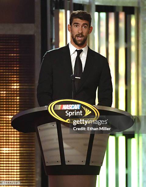 Olympic swimmer Michael Phelps introduces NASCAR Sprint Cup Series Champion Jimmie Johnson during the 2016 NASCAR Sprint Cup Series Awards show at...