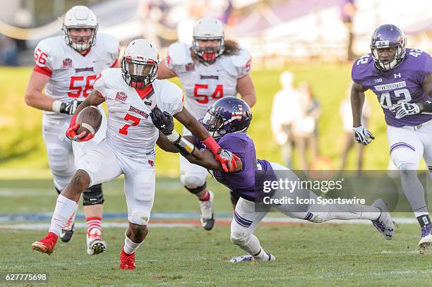 Illinois State Redbirds running back George Moreira tried to break away from Northwestern Wildcats safety Kyle Queiro during an NCAA football game...