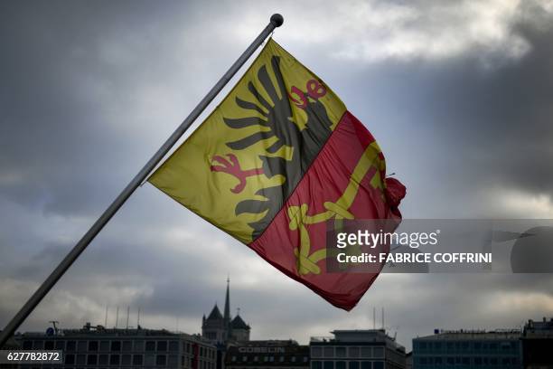 Flag of the city and canton of Geneva is pictured in front of the St Pierre Cathedral on December 4, 2016 in Geneva.