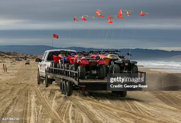 Truck loaded with ATVs drives along the sand at Oceano Dunes/Pismo Beach State Park on November 27 near Pismo Beach, California. Because of its close...