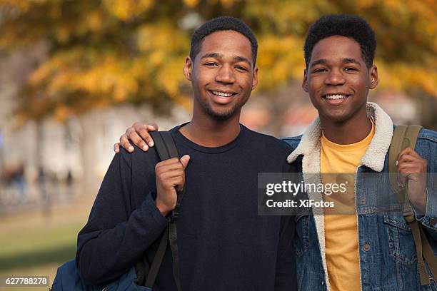 twin college students - brother stock pictures, royalty-free photos & images