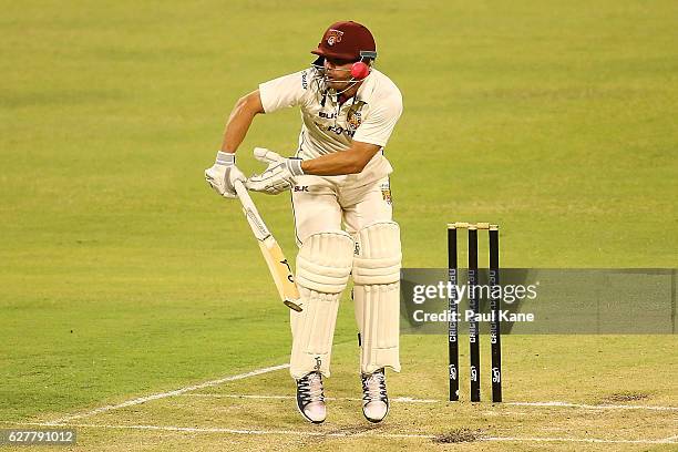 Chris Hartley of Queensland fends off an uppish delivery during day one of the Sheffield Shield match between Western Australia and Queensland at...