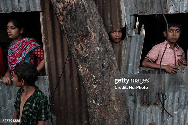 Terrified neighbours looks on as the fire breaks out at the Korail Slum after the fire came in control at Dhaka, Bangladesh, 04 December 2016. The...