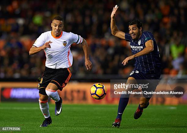 Rodrigo Moreno of Valencia competes for the ball with Miguel Torres of Malaga during the La Liga match between Valencia CF and Malaga CF at Mestalla...