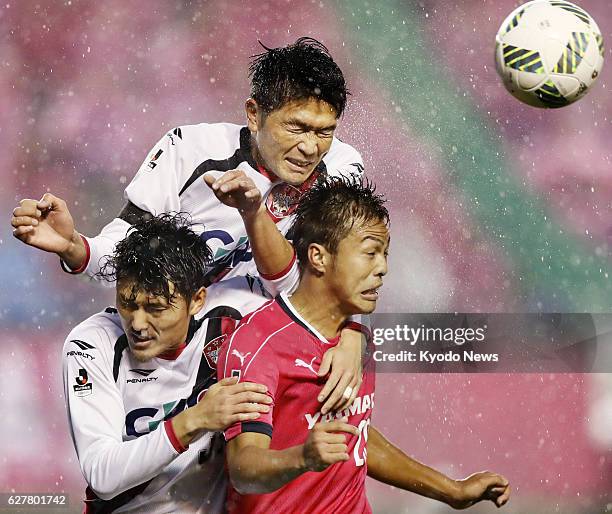 Ryuji Sawakami of Cerezo Osaka and Daiki Iwamasa of Fagiano Okayama vie for the ball during the second half of the J-League promotion playoff final...