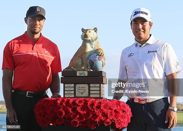 Hideki Matsuyama of Japan and American Tiger Woods pose for photos at Albany Golf Club in the Bahamas on Dec. 4 after completing the final round of...