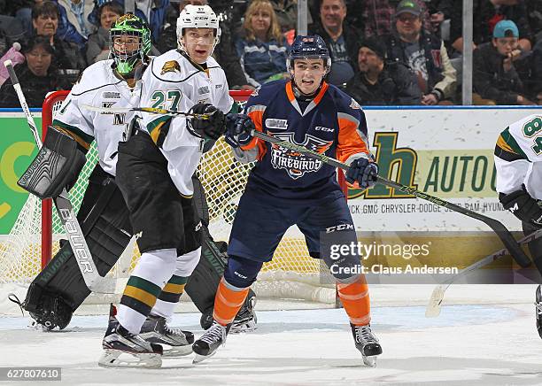 Ryan Moore of the Flint Firebirds skates against Robert Thomas of the London Knights during an OHL game at Budweiser Gardens on December 4, 2016 in...