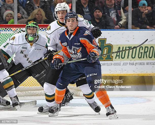 Ryan Moore of the Flint Firebirds looks for a shot to tip in front of Robert Thomas of the London Knights during an OHL game at Budweiser Gardens on...