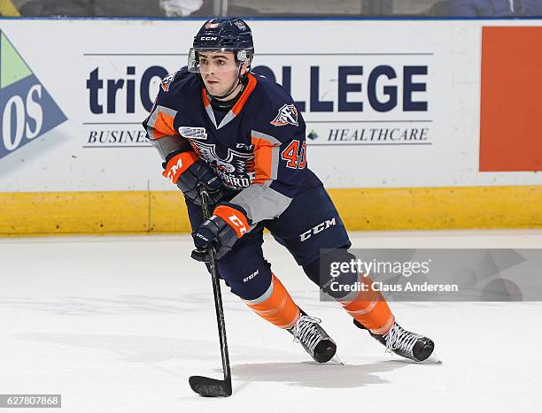 Ryan Moore of the Flint Firebirds skates with the puck against the London Knights during an OHL game at Budweiser Gardens on December 4, 2016 in...