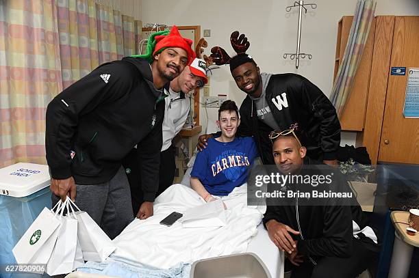 James Young, Al Horford, and Jaylen Brown of the Boston Celtics spread holiday cheer duing a children's hospital visit on December 1, 2016 at Boston...