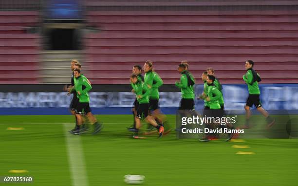 Players warm up during a VfL Borussia Moenchengladbach training session on the eve of their UEFA Champions League match against FC Barcelona at Camp...