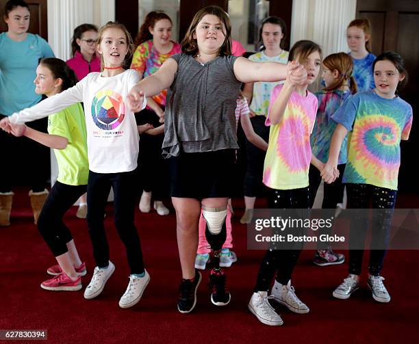Jane Richard, center. Is pictured with other members of a dance group during a rehearsal of their routine that they performed in Boston on Dec. 3,...
