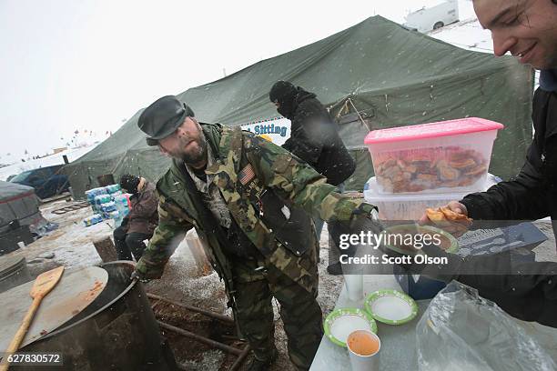 Jarrod Phillips and Air Force veteran from St. Louis, Missouri serves stew to other veterans at Oceti Sakowin Camp on the edge of the Standing Rock...