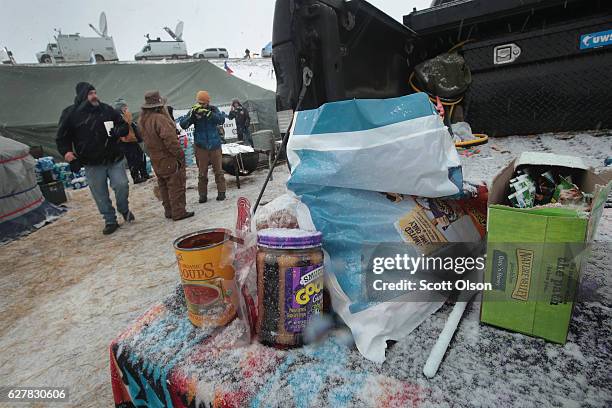 Food gets covered by snow as it sits on a truck tailgate in one of the military veteran camps at Oceti Sakowin Camp on the edge of the Standing Rock...