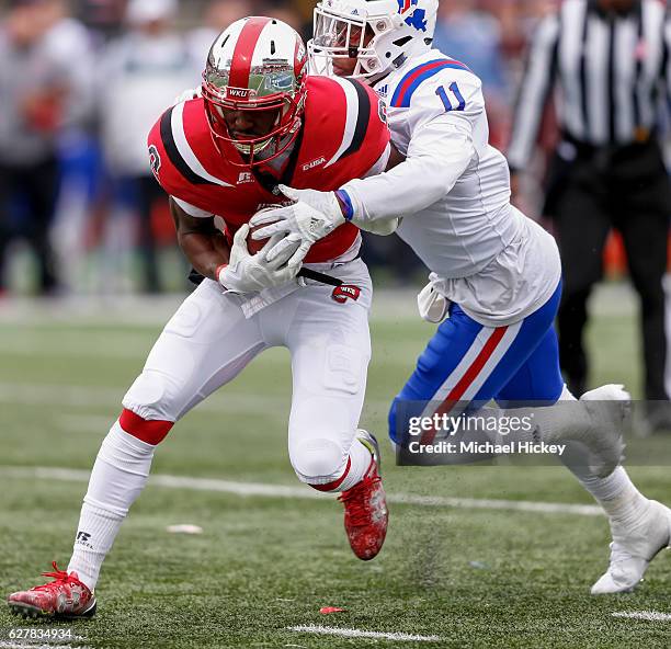 Taywan Taylor of the Western Kentucky Hilltoppers runs the ball and is tackled by Lloyd Grogan of the Louisiana Tech Bulldogs at Houchens-Smith...