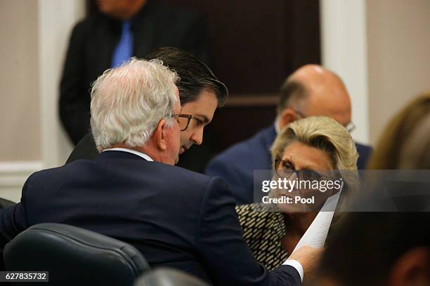 Defense attorney Andy Savage, left, assistant Cheryl Savage look at a document with former North Charleston police officer Michael Slager at the...