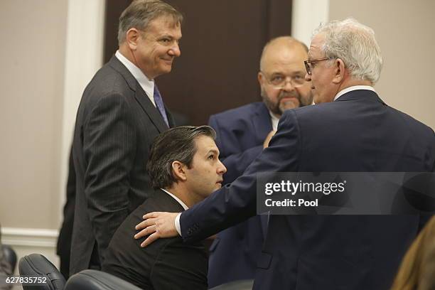 Defense attorneys Don McCune, left, Andy Savage and Miller Shealy surround former North Charleston police officer Michael Slager after a note was...