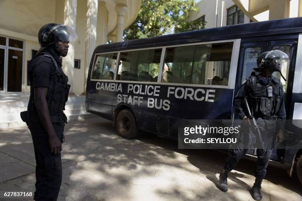 Gambian police officers stand guard outside the Supreme Court of Gambia after an opposition leader was freed on bail along with 18 others in Banjul...